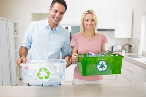 Workers managing waste with skip bins
